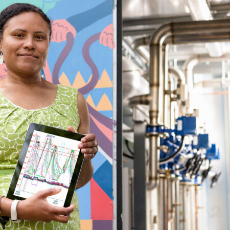 a person holds a tablet with graphs on it