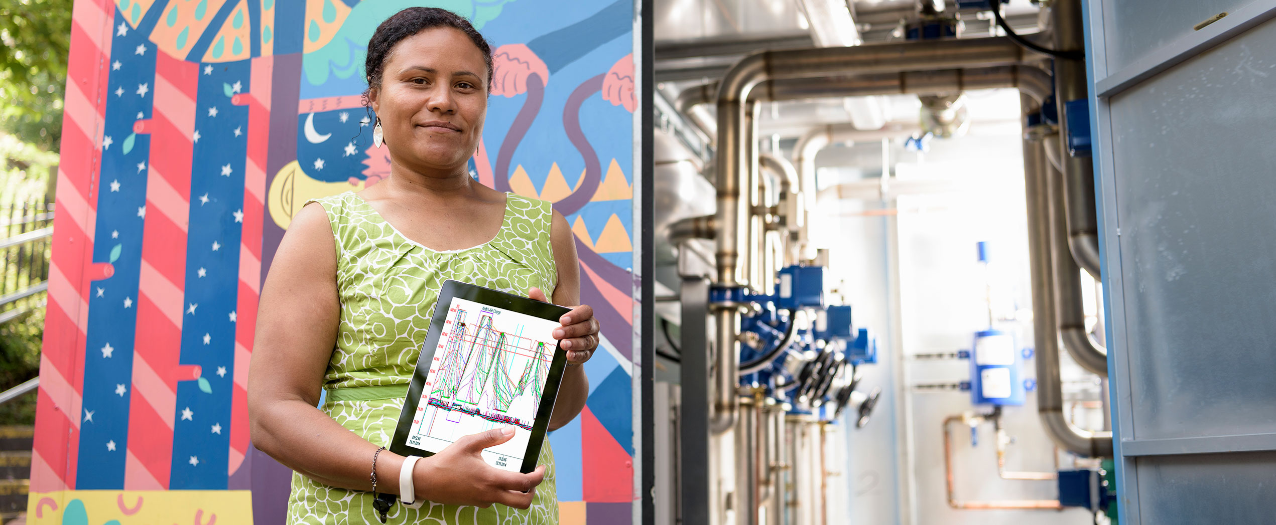 a person holds a tablet with graphs on it