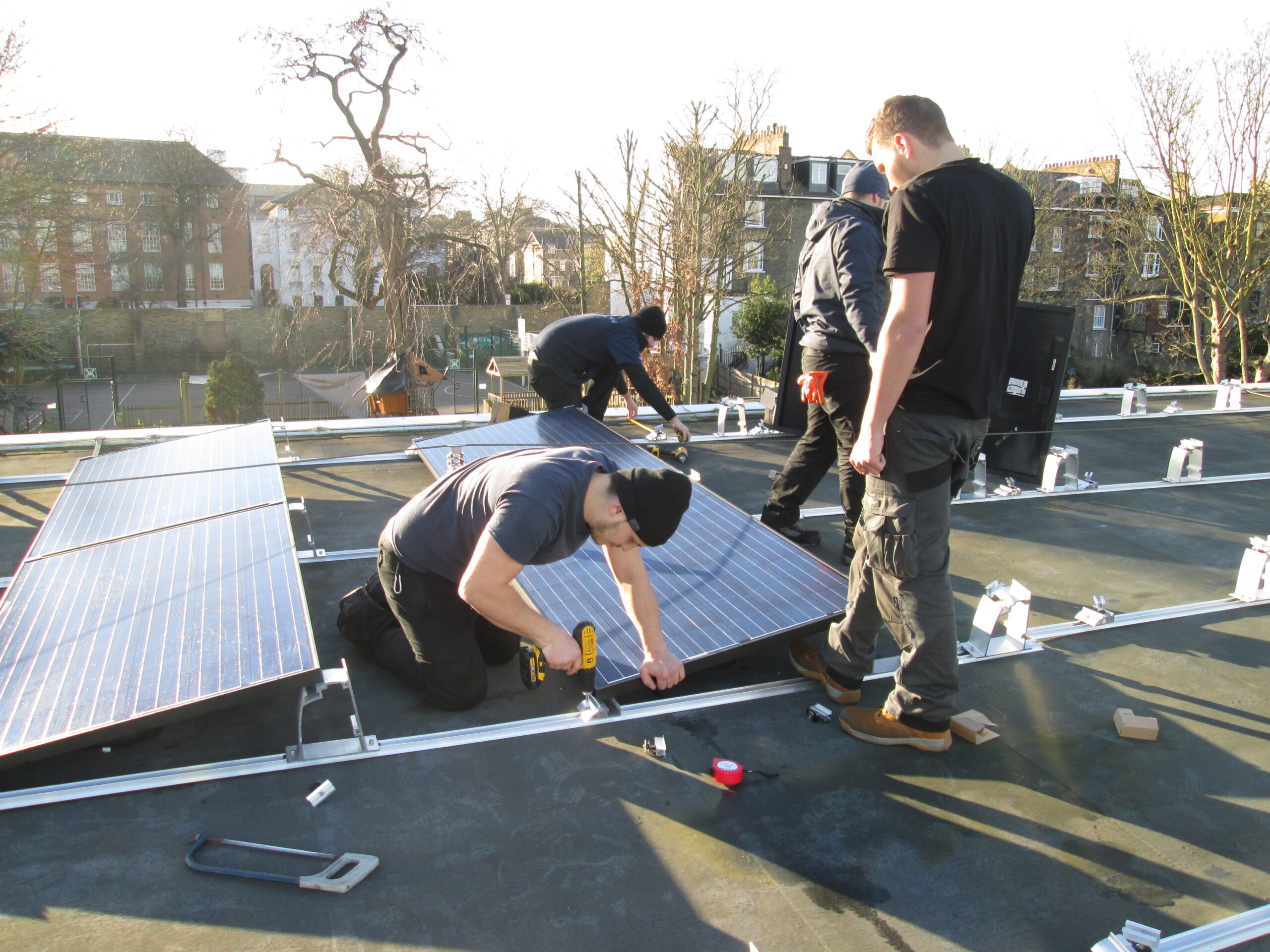 people install solar panels on a roof