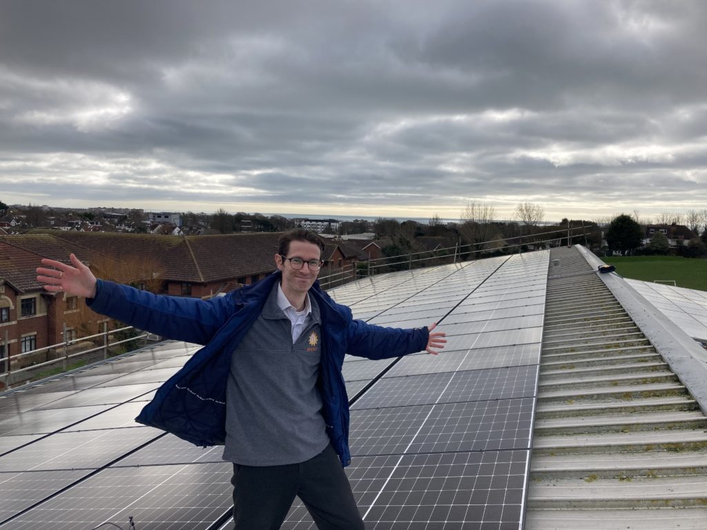 a person stands on a roof that is covered in solar panels